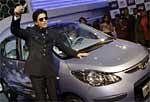 Bollywood actor Shahrukh Khan gestures as he poses at a preview of the Hyundai i10 Electric car at the 10th Auto Expo in New Delhi, Wednesday. AP