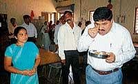 Directorate of Civil Enforcement Superintendent of Police Mithra Heraje tasting the food at Morarji Desai Residential hostel at Karnadu on Wednesday. DH photo