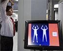 In this Dec. 28, 2009 file photo, an employee of Schiphol stands inside a body scanner during a demonstration at a press briefing at Schiphol airport, Netherlands. AP