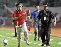 Watch me! Hendri Mulyadi dribbles away as Indonesias coach Benny Dolo looks on in Jakarta on Thursday. AP