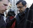 Anil Kumar, center, a director at McKinsey & Co. Inc., arrives at Manhattan Federal court on Thursday in New York. AP