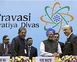 Prime Minister Manmohan Singh shakes hands with chief guest Lord Khalid Hameed of Hampstead as Minister of Overseas Indian Affairs Vayalar Ravi looks on, during the inaugural session of 8th Pravasi Bharatiya Divas - 2010 at Vigyan Bhawan in New Delhi on Friday. PTI