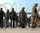 Police officials block the road during a gunbattle in Srinagar on Thursday. AFP