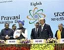 Prime Minister Manmohan Singh releases the book 'Investment Tool Kit for Global Indians' as chief guest Lord Khalid Hameed of Hampstead, Minister of Overseas Indian Affairs Vayalar Ravi and Delhi Chief Minister Sheila Dikshit look on, during the inaugural session of 8th Pravasi Bharatiya Divas - 2010 at Vigyan Bhawan in New Delhi on Friday. PTI