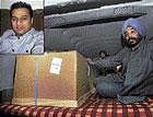 Grieving kin Pritam Singh, a relative of Nitin Garg (inset) who was stabbed to death in Melbourne, sits in an ambulance beside the body of Garg, after it was brought to the Delhi airport on Saturday. PTI