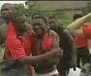 In this image made from the video provided TPA via APTN, Togo soccer players react after a bus bringing them to Angola was attacked by gunmen, in Cabinda province, Angola on Friday. AP