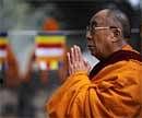 Tibetan spiritual leader The Dalai Lama prays during a special prayer session at The Mahabodhi Temple in Bodhgaya on  Friday.  AFP