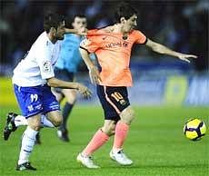 Barcelona's Lionel Messi (right) duels for the ball against Tenerife's Ezequiel Luna of Argentina during a Spanish La Liga soccer match on Sunday. AP