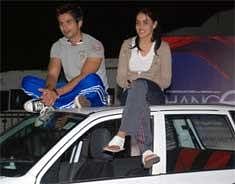 Indian Bollywood actor Shahid Kapoor (L) and actress Genelia DSouza pose on the roof of a car at a promotion ceremony for the film 'Chance Pe Dance' at Kamlistan Studios in Mumbai. AFP