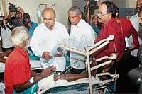 Medical Education Minister Ramachandra Gowda speaking to a patient at Wenlock hospital in Mangalore on Monday.