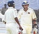 time to go Ajit Agarkar (right) makes a reluctant return to the pavilion after he was adjudged run out.  Umpire Amiesh Saheba and Vinayak Samant are also seen. dh photo