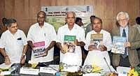 Chief Minister B S Yeddyurappa displays a copy of District Human Development reports of Bijapur, Gulbarga, Mysore and Udupi districts released in Bangalore on Monday. Home Minister V S Acharya, State Planning Board Deputy Chairman D H Shankarmurthy and Planning & Statistics Minister Govind Karjol are also seen. DH Photo
