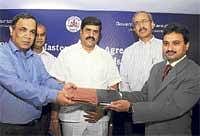 SSLR Commissioner Rajeev Chawla (left), Navayuga Infotech CEO P Chandrashekar Reddy exchange files after signing an agreement for Urban Property Ownership Record. Revenue  Minister G Karunakara Reddy (centre)is also seen. DH Photo