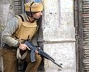 A policeman stands alert during an encounter in Srinagar on January 6, 2010. File photo/AFP