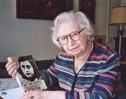 In this 1998 photo Miep Gies displays a copy of her book 'Anne Frank Remembered' at her apartment in Amsterdam, Netherlands. AP