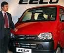 S N Barman, Commercial Business Head, Maruti Suzuki, poses next to company's EECO car during its launch in Kolkata on Wednesday. PTI