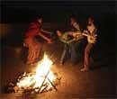 A Sikh family celebrates the Lohri festival around a fire, on the terrace of their house in Amritsar, India, Wednesday. AP