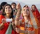 Young girls enjoy kite fying on the eve of Makar Sankranti festival in Ajmer on Wednesday. PTI