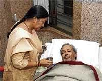 A relative of K S Ashwath attending to ailing actor in a  private hospital in Mysore on Wednesday. DH Photo