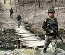 CRPF jawans patrol a village as security has been tightened in south Kashmir after a gunbattle with a Hizbul Mujahideen militant in Pulwama on Wednesday. PTI