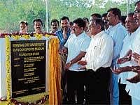 Well Begun: Union Minister of State for Youth Affairs and Sports Pratik Prakashbapu Patil unveiling a plaque to mark laying of  foundation stone for Mangalore University outdoor sports stadium at Mangalagangothri on Thursday. DH Photo