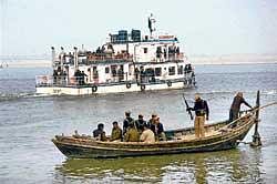 Securitymen keep vigil near a floating restaurant in the river Ganga where Bihar Chief Minister Nitish Kumar held a cabinet meeting in Patna on Thursday. Pti