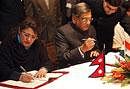 Foreign Minister S.M. Krishna(R) and Nepal's Deputy Prime Minister and Foreign Minister Sujata Koirala sign a memorandum of understanding in Katmandu, Nepal on Friday. AP