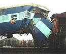 Passengers near the damaged coach of Shramshakti Express after Kalindi Express rammed into it near Tundla on Saturday. PTI