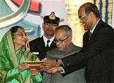 RBI Governor D Subbarao presents a memento to President Pratibha Patil as Finance Minister Pranab Mukhejee looks on, at the Platinum Jubilee celebration of Reserve Bank of India in New Delhi on Saturday. PTI