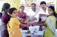 Initiative: MLA B B Ramaswamy distributing sanction letters to the beneficiaries at a janaspandana programme in Kothagere in Kunigal taluk on Saturday.  TP President Varalakshmi, GP President Narayan and others are seen. dh photo