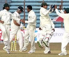 Bangladesh players celebrate the wicket of VVS Laxman during the first test match between India and Bangladesh in Chittagong on Sunday. AP