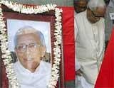 West Bengal Chief Minister Buddhadeb Bhattacharjee near former Chief Minister Jyoti Basu's portrait placed at CPI(M) office for people to pay respect to him, in Kolkata on Monday. PTI