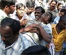Students carry a man injured during a protest at Osmania University in Hyderabad on Wednesday. AFP