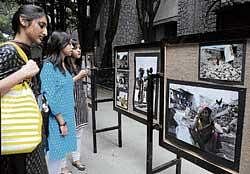 Students taking a look at the photographs exhibited.