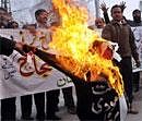 Pakistani cricket fans shout slogans beside a burning effigy of Indian Premier League (IPL) Commissioner Lalit Kumar Modi during a protest in Lahore on Wednesday. AFP