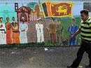 A Sri Lankan man walks past a wall painting depicting the country's multi-cultural and multi-religious life in Colombo on Thursday. AFP