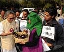 Union Minister for Environment and Forests, Jairam Ramesh interacts with protesters as he arrives for the genetically modified BT Brinjal Consultancy program in Ahmedabad on January 19, 2010. AFP