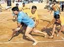 Uttar Pradesh Wests Punit Krtootia is caught by Karnatakas Sandeep Chouti and   S Suresh (extreme right) in the all-India BSNL kabaddi tournament on Thursday. DH photo