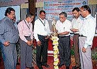 Mangalore University in charge VC Prof K K Achary lighting the lamp at a seminar on rain water harvesting and artificial recharge to ground water with special reference to Coastal areas, on Thursday.