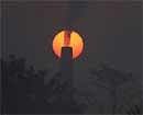 Sun rises behind a chimney of brick kiln at Chandrapur, India on Friday. AP