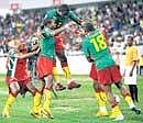 Cameroon players celebrate Nguemos equaliser against Tunisia in the African Nations Cup on Thursday. AP