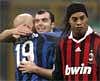 AC Milan Brazilian forward Ronaldinho (R), reacts as in background Inter Milan Argentine midfielder Esteban Cambiasso (L), celebrates with teammate Goran Pandev who just scored his side second goal in a Italian Serie A soccer match at the San Siro stadium in Milan. AP
