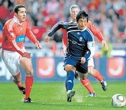 Indias Bhaichung Bhutia, playing for Zidane and Friends team, dribbles past Benfica All Stars Paulo Madeira (left) during their Match Against Poverty in Lisbon on Monday. AFP