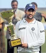 PROUD MAN:  MS Dhoni poses with the trophy after winnng the Test series against Bangladesh on Wednesday. REUTERS