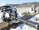 Battle ready: A South Korean Army soldier aims his machine gun during an exercise against possible attacks from North Korea near the demilitarised zone in Yanggu, South Korea, on Wednesday. AP