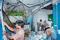 Workers seen demolishing the shops in a multi-storeyed building in Balmatta.