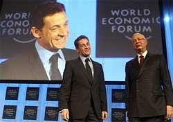 French President Nicolas Sarkozy, left, stands with World Economic Forum founder Klaus Schwab before making the opening address at the World Economic Forum in Davos, Switzerland, AP