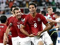 Red hot:  Hosny Abd Rabo (right) of Egypt celebrates his goal against Algeria. AFP