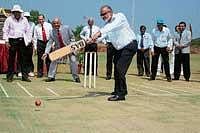 Secretary of Karnataka State Cricket Association Brijesh Patel inaugurating a turf wicket at Manipal Univertsity by batting, while Manipal University Pro-Chancellor  Dr H S Ballal (behind) plays the wicket keeper, in Manipal  on Friday. DH photo