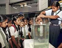 Schoolchildren viewing a model at the Science in Action  exhibition at Jawaharlal Nehru Planetarium on Friday.  DH PHOTO